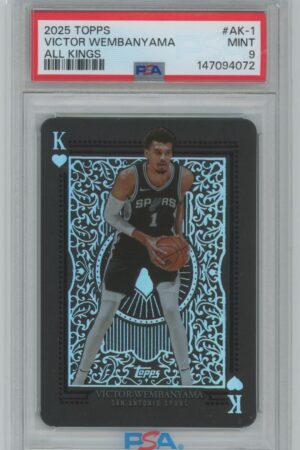 A graded 2025 Topps All Kings trading card featuring Victor Wembanyama of the San Antonio Spurs, shown as the King of Hearts, holding a basketball in a black and silver card design.