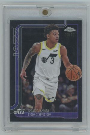 A basketball trading card of Keyonte George in a Utah Jazz uniform, holding a basketball. The card is encased in a plastic holder and features dark purple accents and the number 3 on George’s jersey.